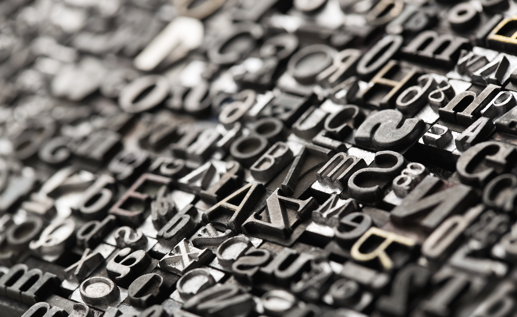 Letterpress background, close up of many old, random metal lette